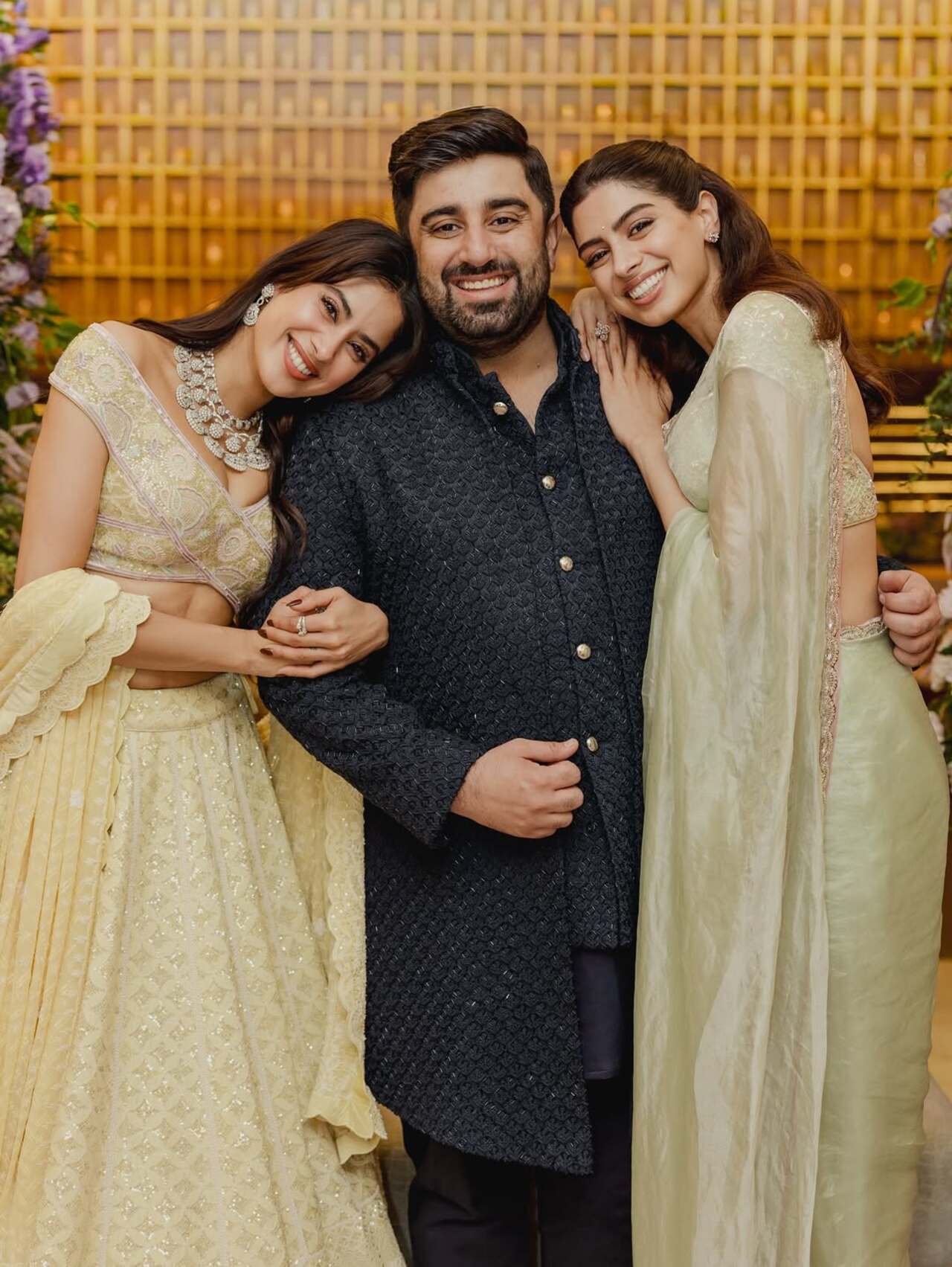 Janhvi Kapoor and Khushi Kapoor posed for a happy picture with brother-in-law Rhan Thakker, Janhvi stunned in a yellow lehanga while Khushi looked gorgeous in a green saree. 